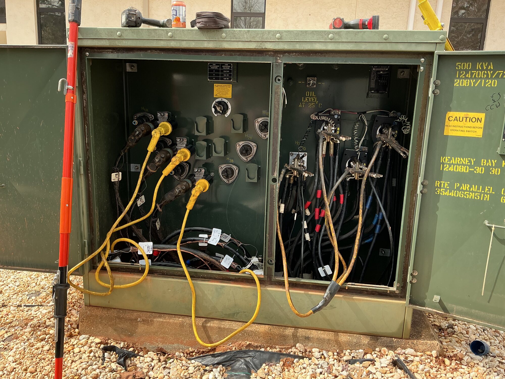 Open electrical transformer cabinet with connected utility cables